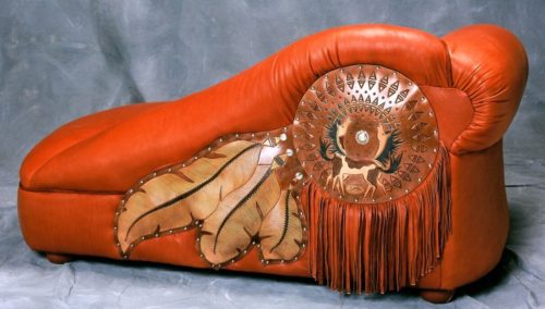 chaise with dramatic tooling and fringe on back side