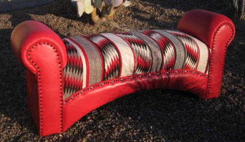 Vintage Navajo weaving on red leather bench